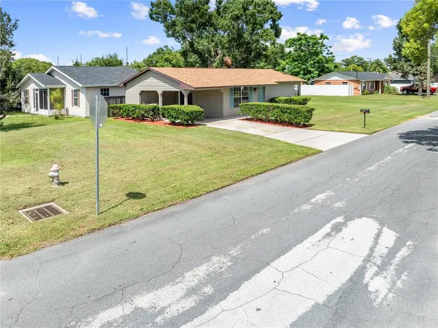 a front view of house with yard and trees