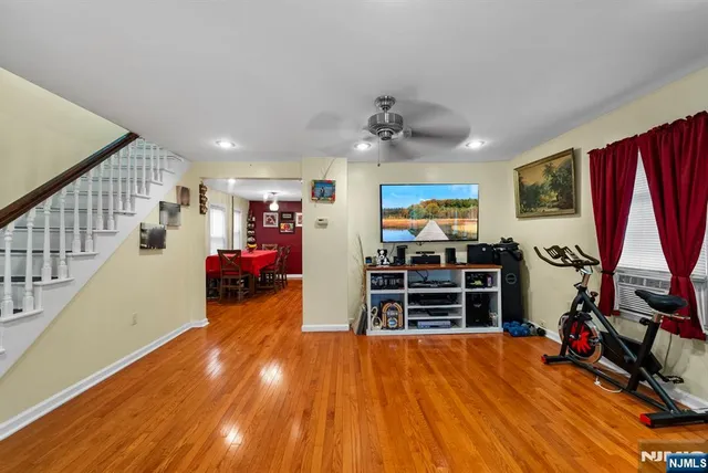 a view of a workspace with furniture and wooden floor