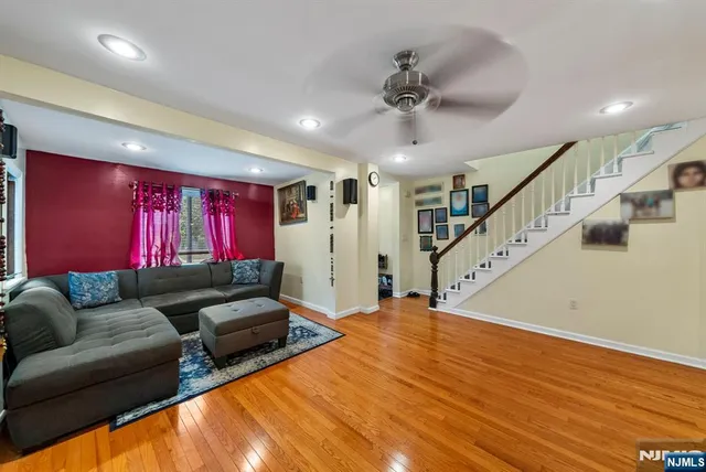 a living room with furniture and stairs