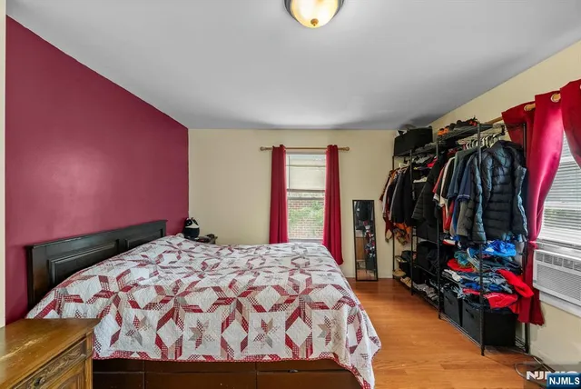 a bed sitting in a bedroom next to a window