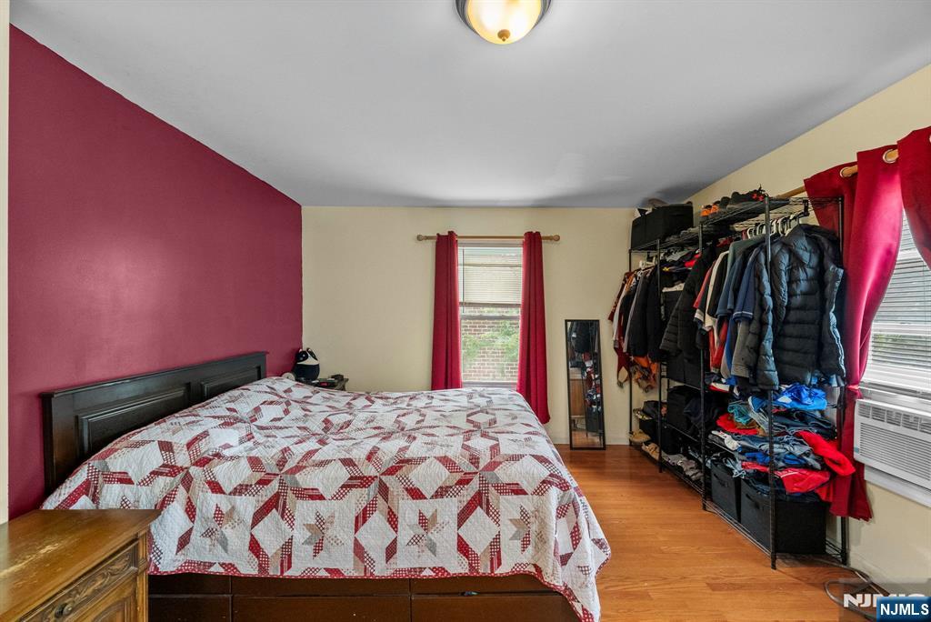 298 3rd Street Hackensack, NJ 07601 - Photo 21 of 36 a bed sitting in a bedroom next to a window
