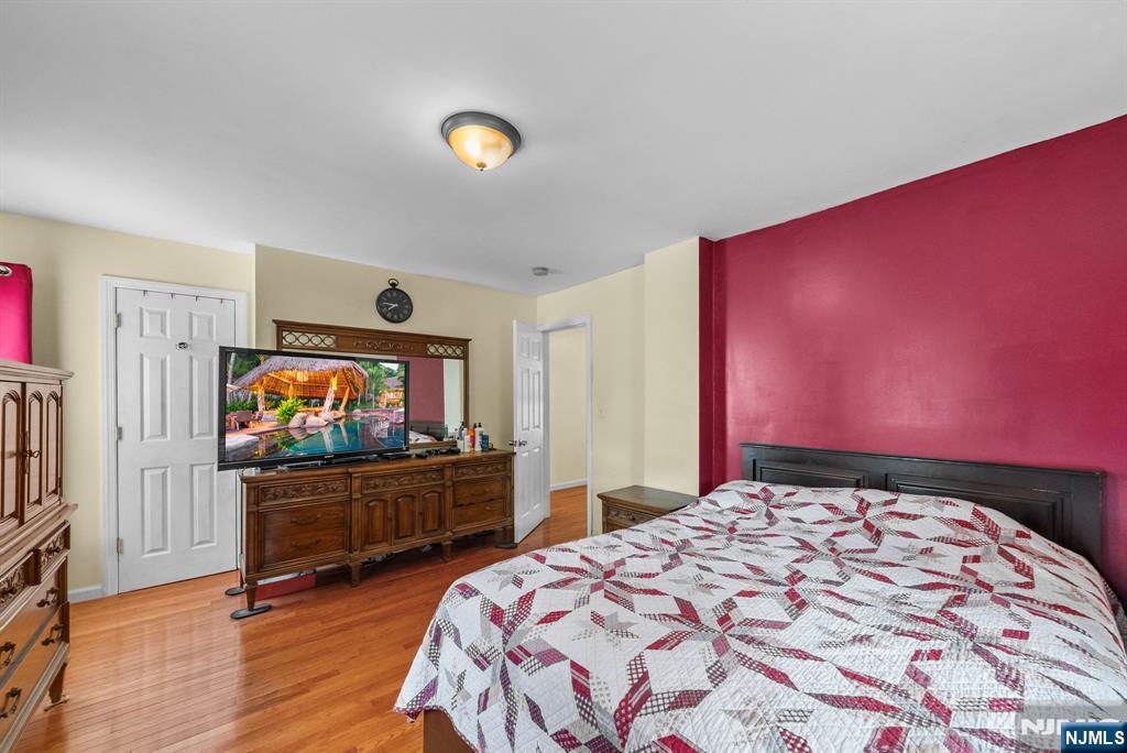 298 3rd Street Hackensack, NJ 07601 - Photo 22 of 36 a bedroom with a bed and a flat screen tv