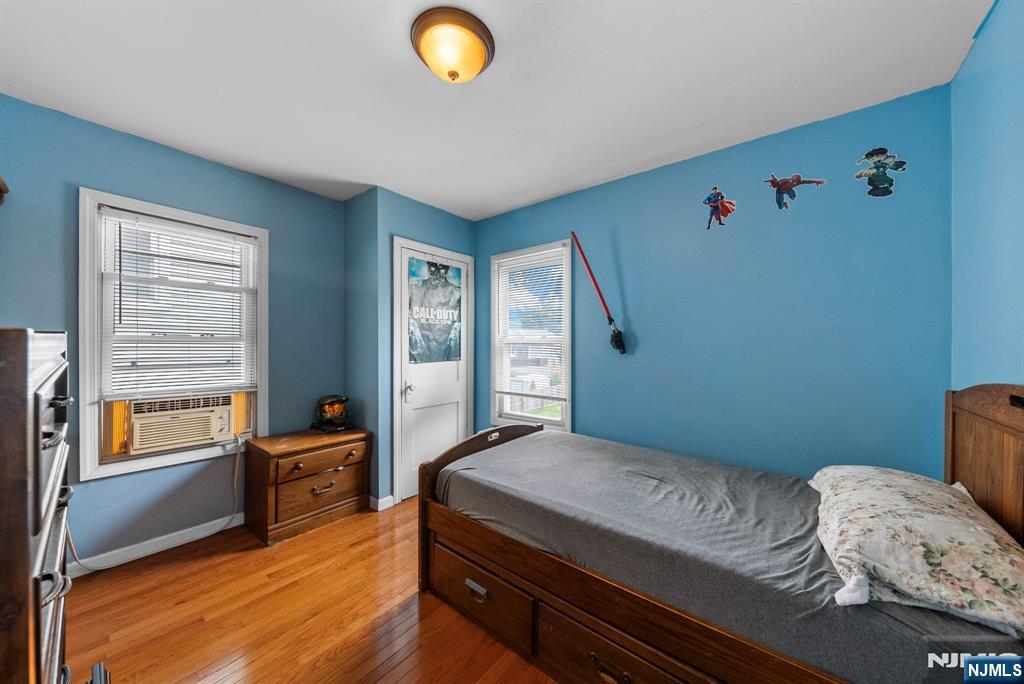 298 3rd Street Hackensack, NJ 07601 - Photo 23 of 36 a bedroom with a bed and wooden floor