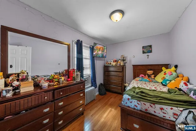 a bedroom with furniture and a baby crib