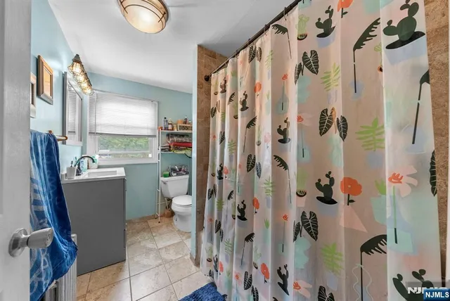 a bathroom with a shower and a toilet