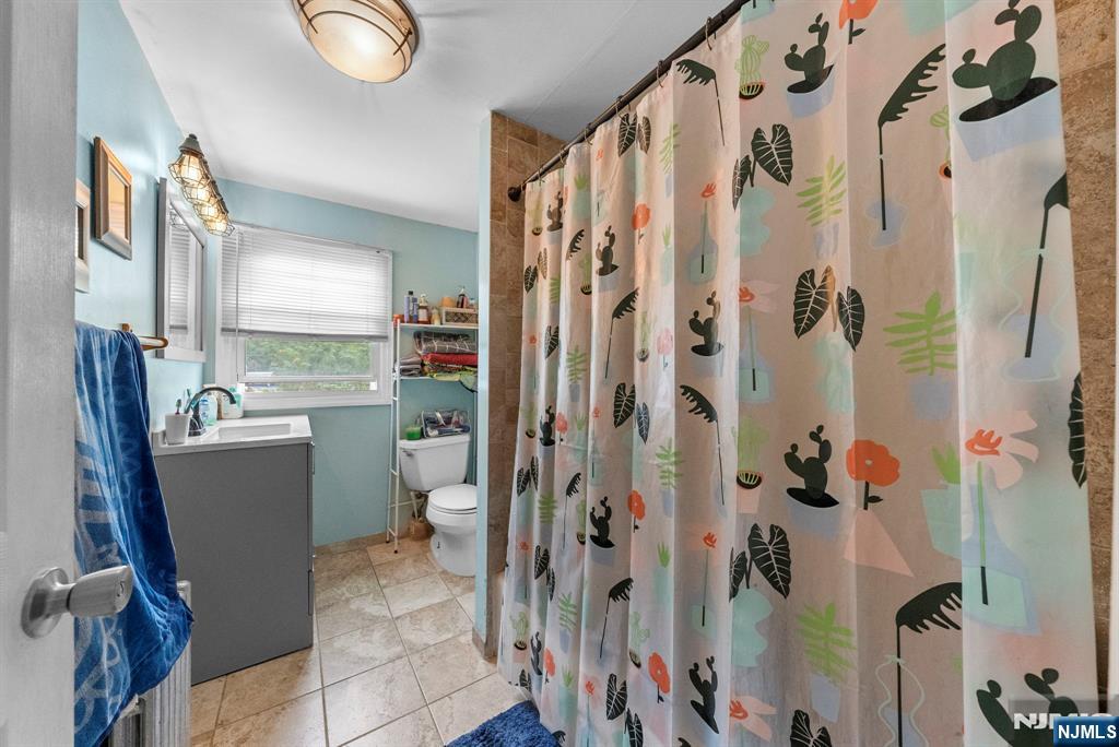 298 3rd Street Hackensack, NJ 07601 - Photo 27 of 36 a bathroom with a shower and a toilet