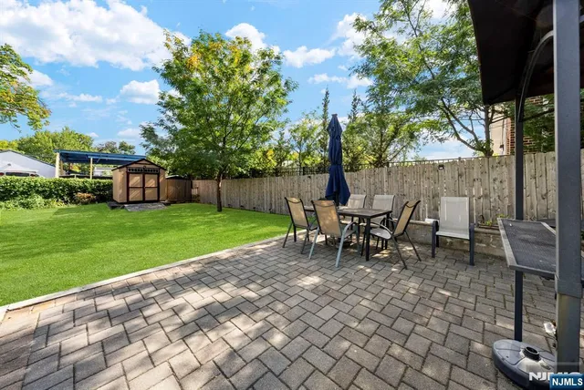 a view of a house with backyard sitting area and garden