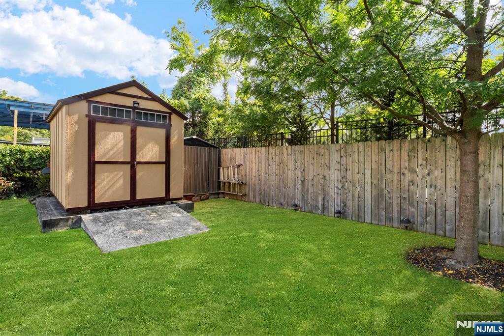 298 3rd Street Hackensack, NJ 07601 - Photo 33 of 36 a view of backyard with a barn and a large tree
