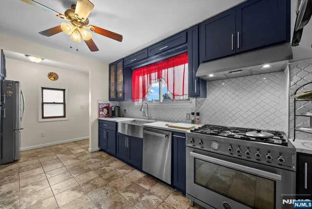 a kitchen with a stove a sink and a microwave