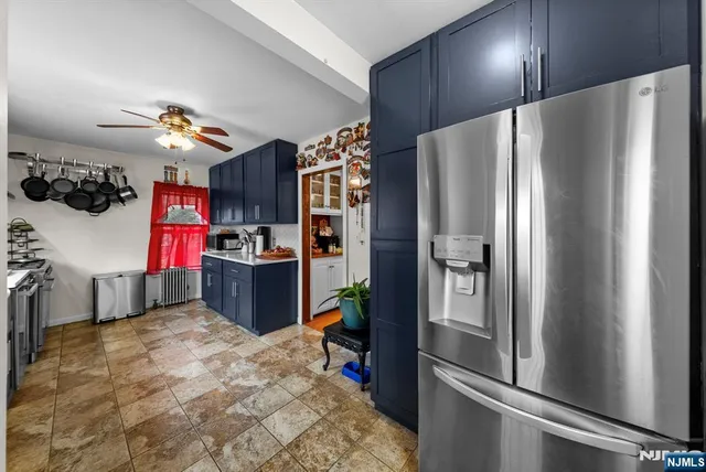 a kitchen with stainless steel appliances granite countertop a refrigerator and a stove