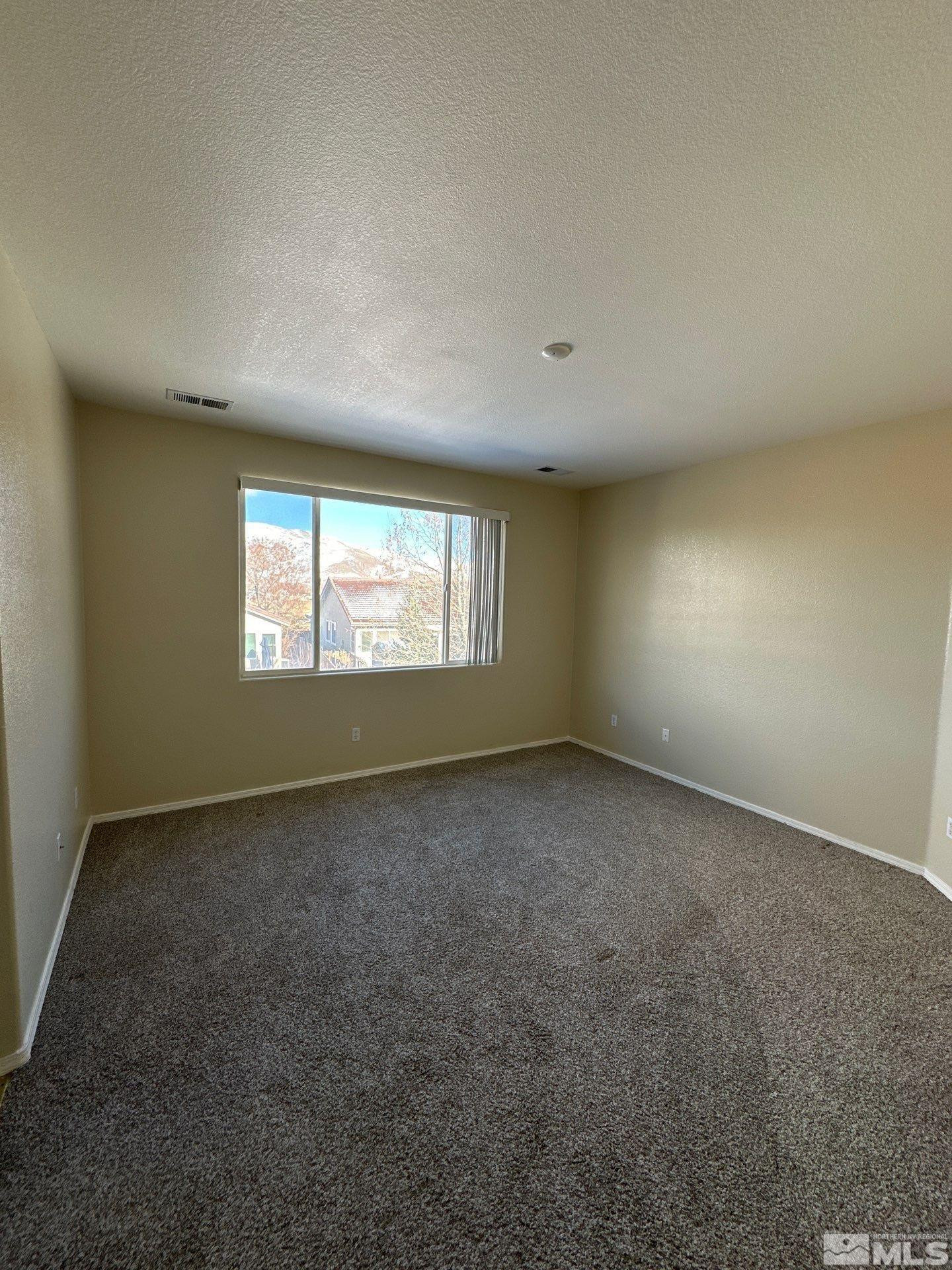 9648 Thunder Mountain Way Reno, NV 89521 - Photo 14 of 27 an empty room with a window