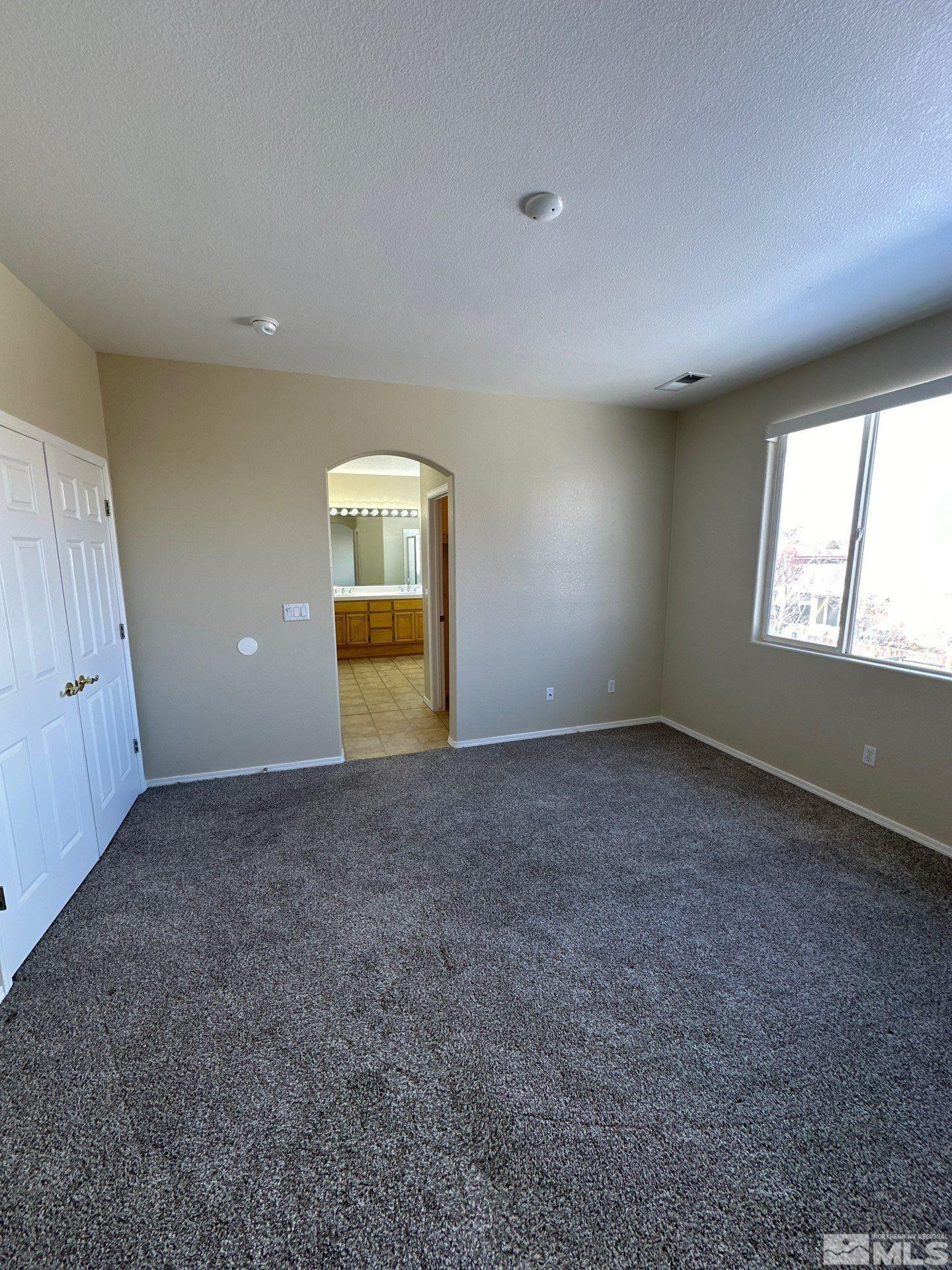 9648 Thunder Mountain Way Reno, NV 89521 - Photo 16 of 27 an empty room with windows and natural light