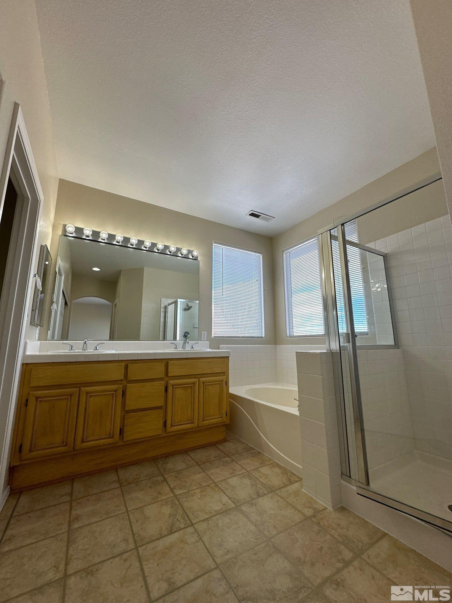 9648 Thunder Mountain Way Reno, NV 89521 - Photo 18 of 27 a large bathroom with a large tub and sink