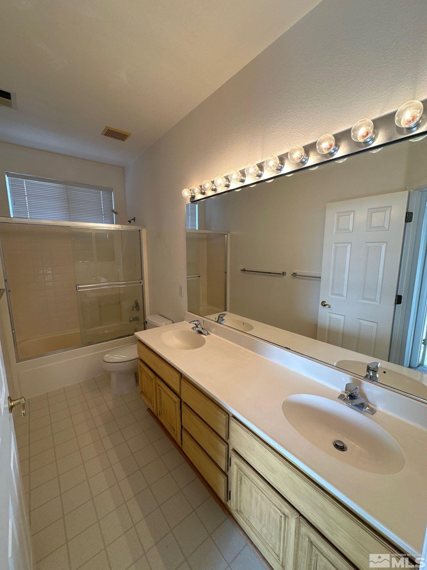 9648 Thunder Mountain Way Reno, NV 89521 - Photo 19 of 27 a bathroom with a sink double vanity and a mirror