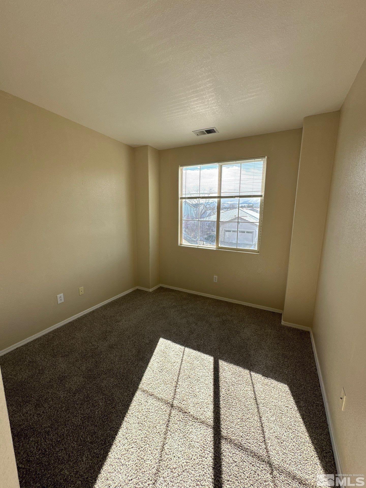 9648 Thunder Mountain Way Reno, NV 89521 - Photo 20 of 27 a view of an empty room and window