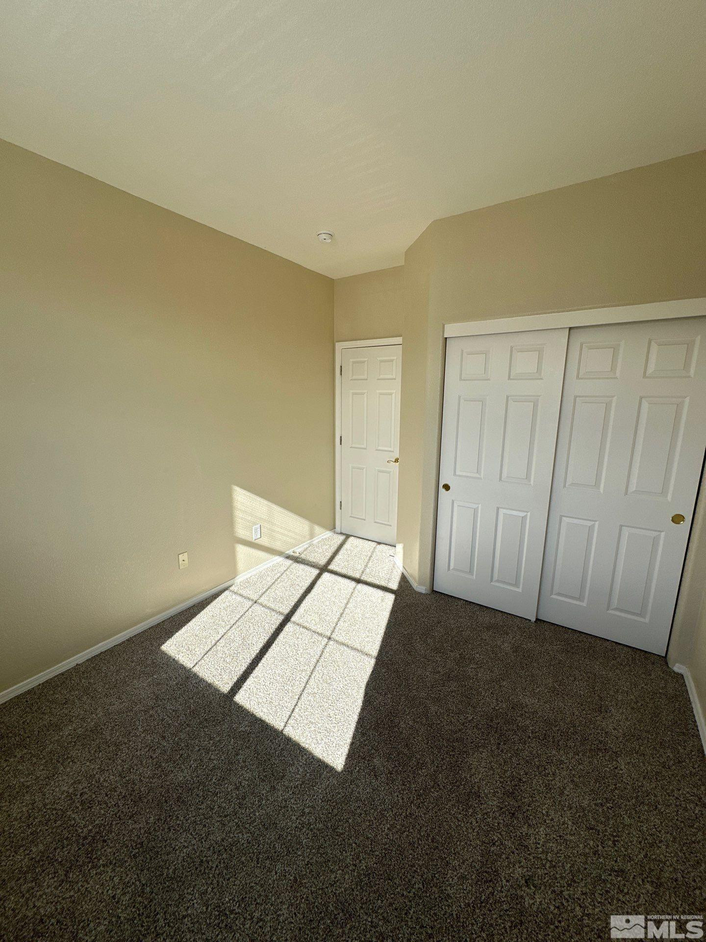 9648 Thunder Mountain Way Reno, NV 89521 - Photo 21 of 27 a view of an empty room and wooden floor