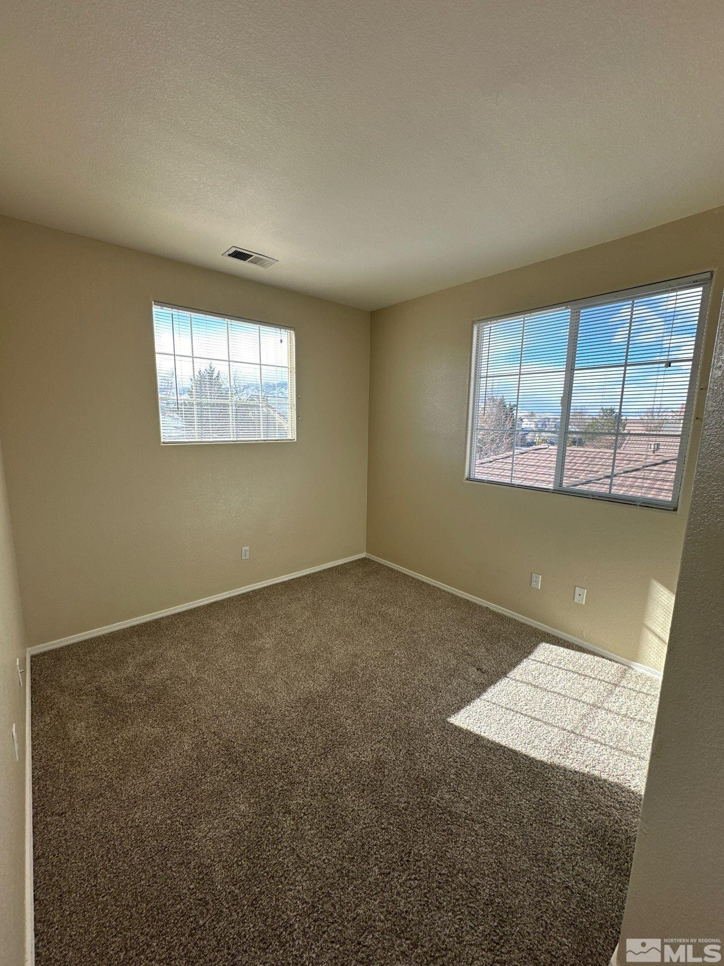9648 Thunder Mountain Way Reno, NV 89521 - Photo 23 of 27 an empty room with windows