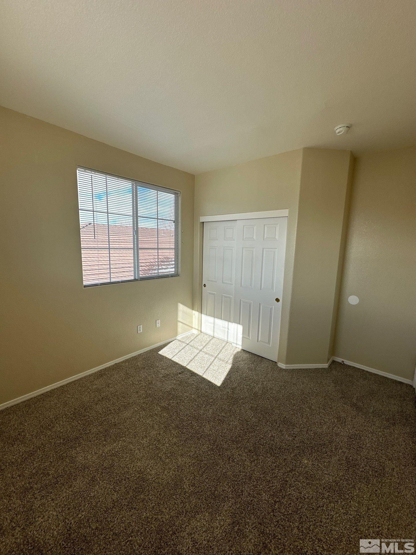 9648 Thunder Mountain Way Reno, NV 89521 - Photo 24 of 27 an empty room with windows