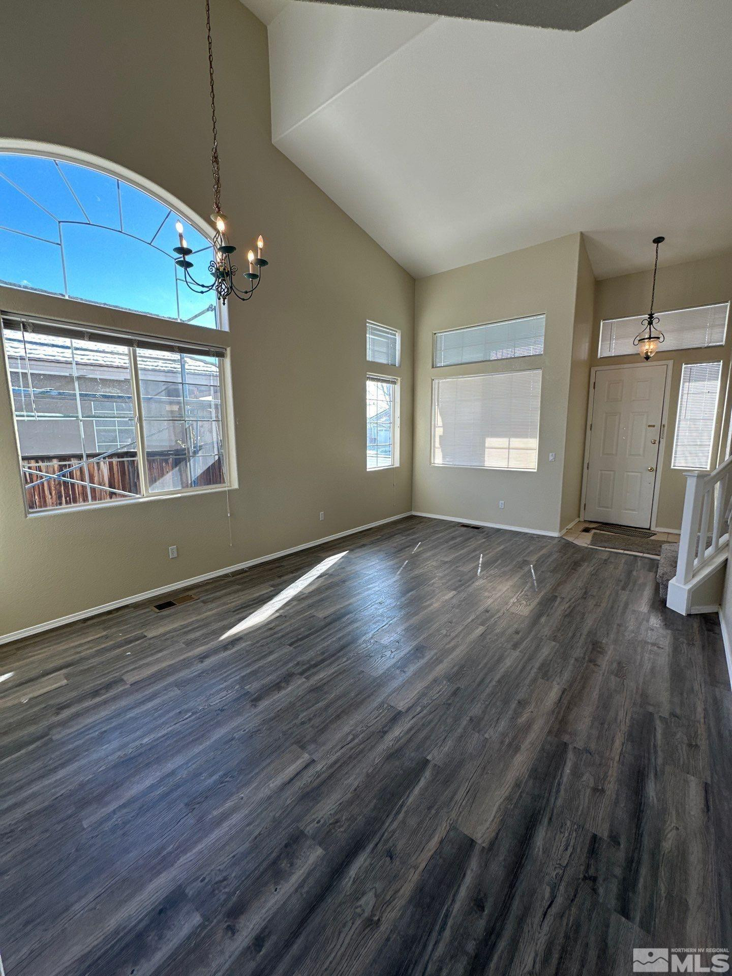 9648 Thunder Mountain Way Reno, NV 89521 - Photo 4 of 27 an empty room with wooden floor and windows