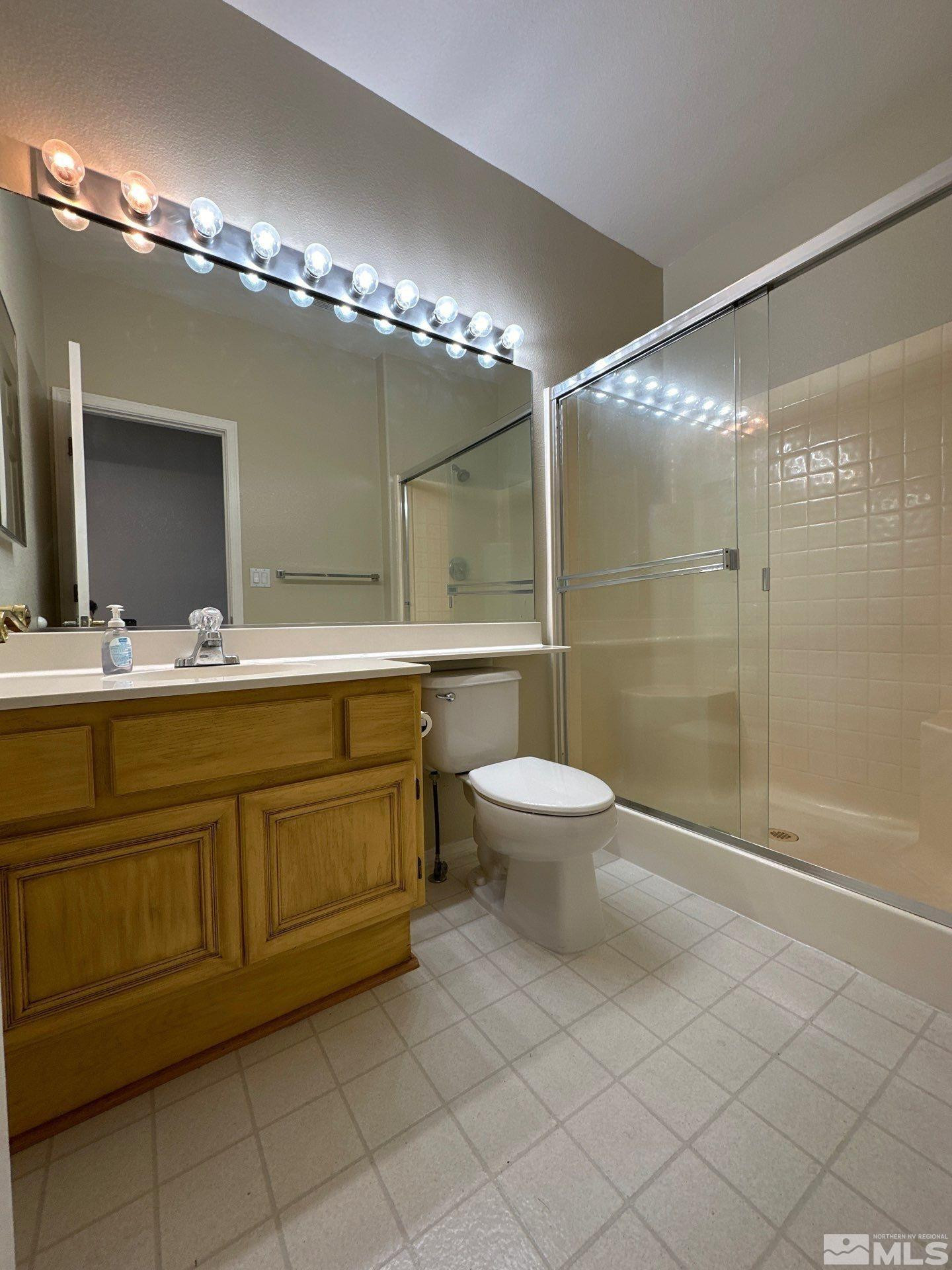 9648 Thunder Mountain Way Reno, NV 89521 - Photo 7 of 27 a bathroom with a double vanity sink mirror and toilet