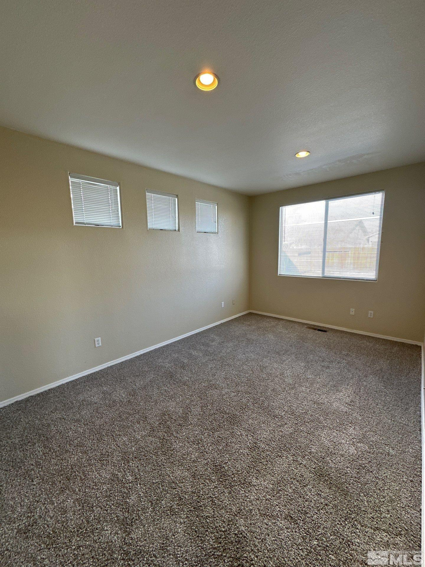 9648 Thunder Mountain Way Reno, NV 89521 - Photo 8 of 27 an empty room with windows