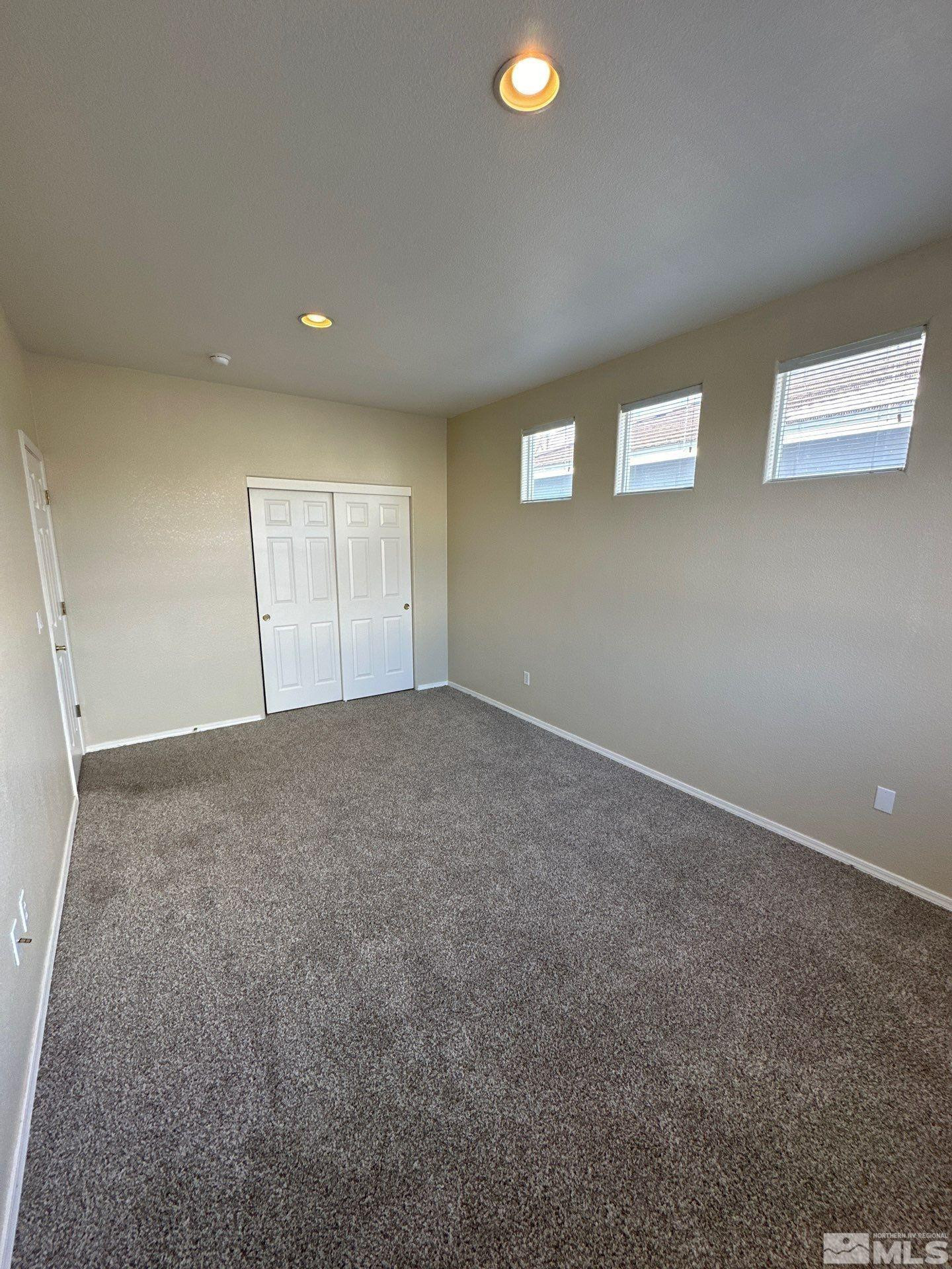 9648 Thunder Mountain Way Reno, NV 89521 - Photo 9 of 27 an empty room with windows
