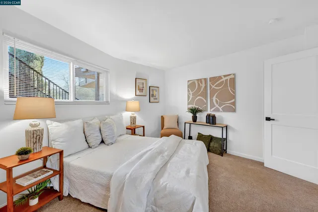 a bedroom with a bed and lamp