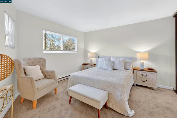 a spacious bedroom with a bed and a large mirror