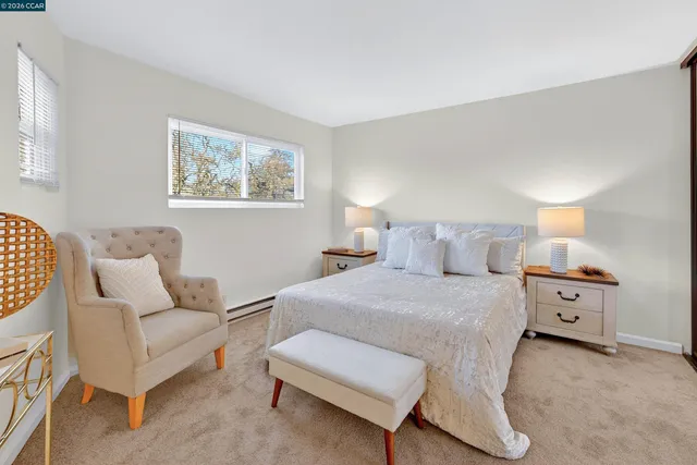 a spacious bedroom with a bed and a large mirror