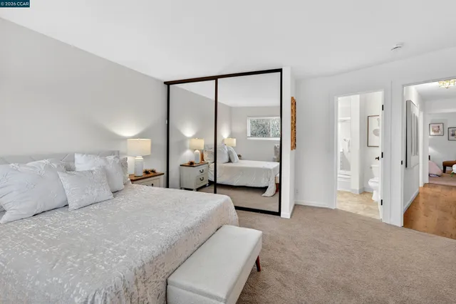 a bathroom with a bathtub shower sink vanity and mirror