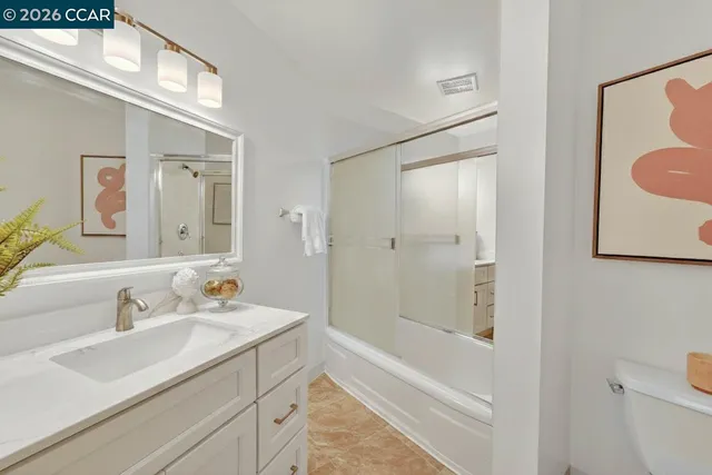 a balcony with wooden floor table and chairs