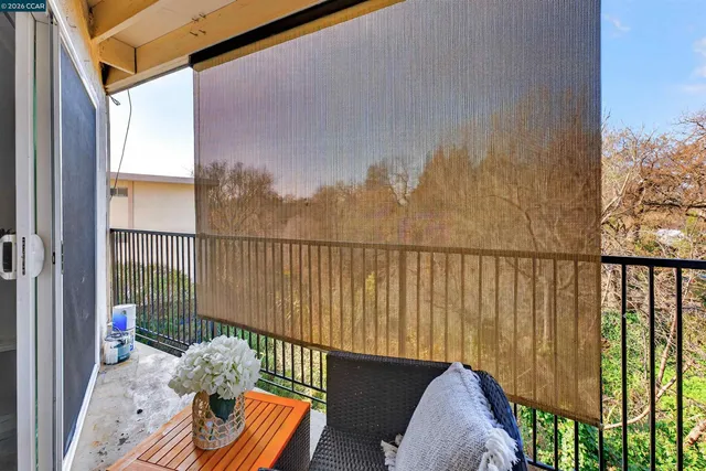 a view of a white building with swimming pool in front of it