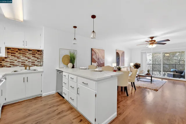 a kitchen with white cabinets and sink