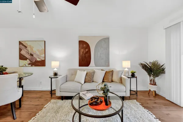 a living room with furniture and a chandelier