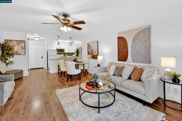 a living room with furniture a fireplace and a large window