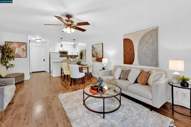a living room with furniture a fireplace and a large window
