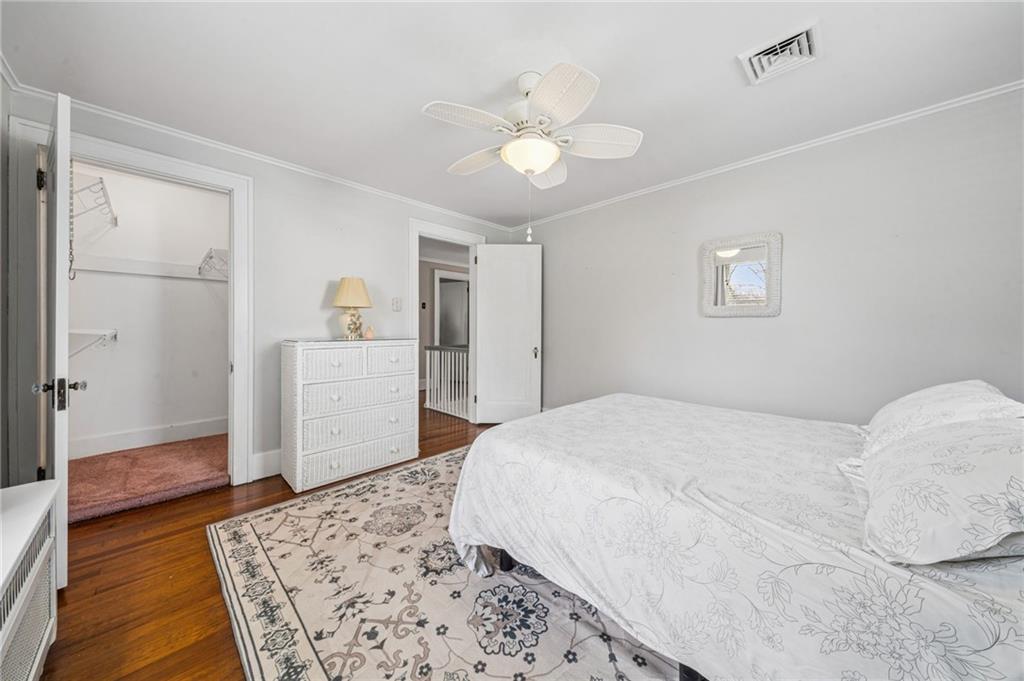 111 Orchard Avenue Rostraver Township, PA 15012 - Photo 24 of 42 a bedroom with a large bed and a chandelier