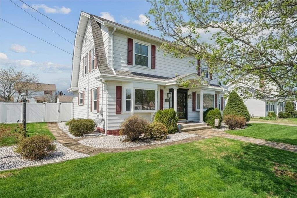 111 Orchard Avenue Rostraver Township, PA 15012 - Photo 3 of 42 a front view of a house with garden and porch