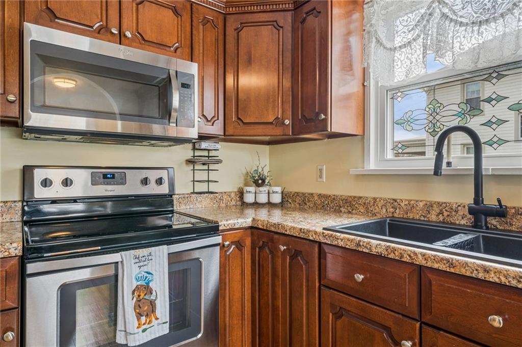 111 Orchard Avenue Rostraver Township, PA 15012 - Photo 8 of 42 a kitchen with stainless steel appliances granite countertop a stove and a microwave