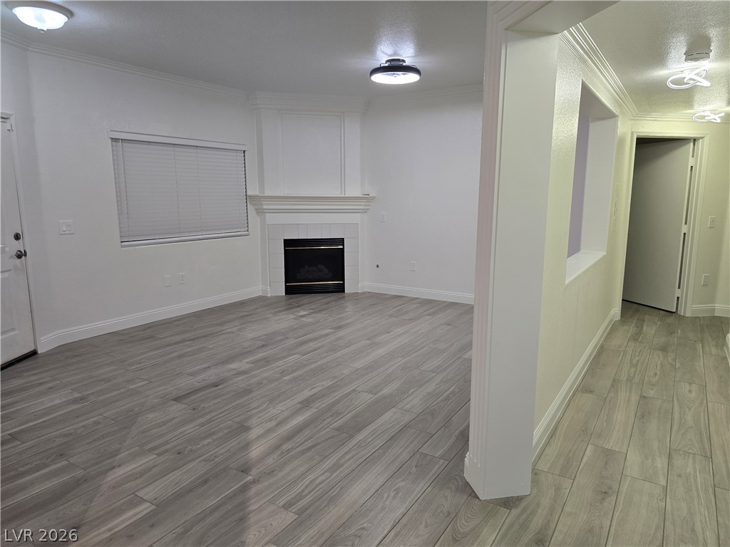 1881 West Alexander Road, Unit 1127 North Las Vegas, NV 89032 - Photo 9 of 20 A refined living space showcasing a cozy fireplace and durable plank flooring.