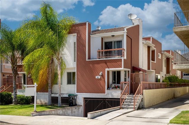 a front view of a residential apartment building with a yard
