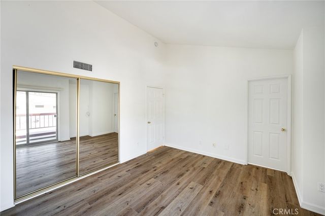 a view of wooden floor and windows in a room
