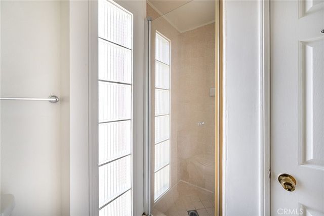 a bathroom with a glass shower door