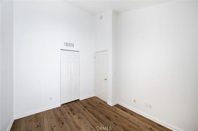 a view of room with wooden floor