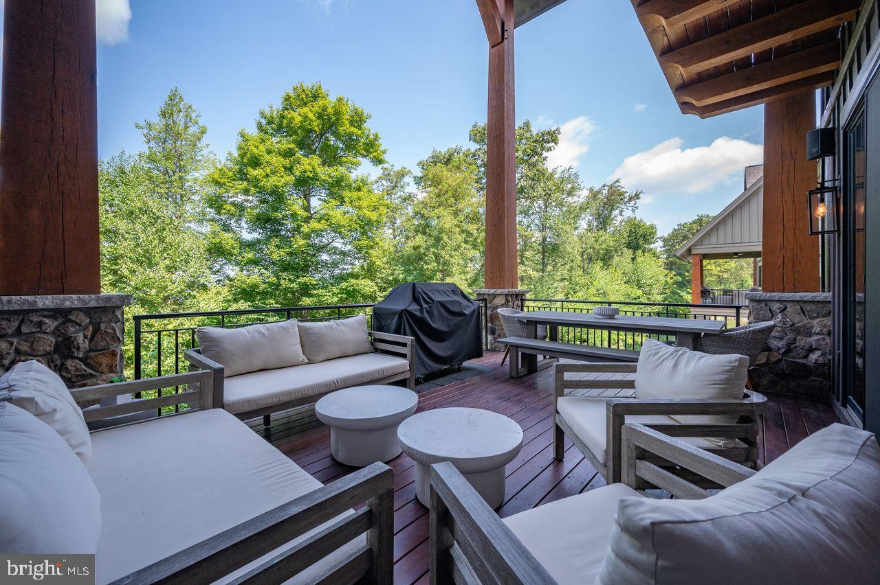 142 Ridge Run Road McHenry, MD 21541 - Photo 12 of 58 a view of a patio with couches chairs and a potted plant