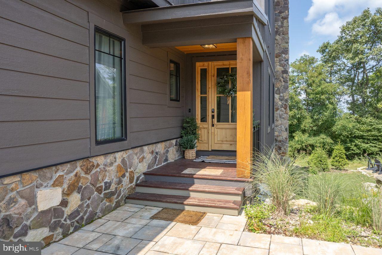 142 Ridge Run Road McHenry, MD 21541 - Photo 2 of 58 a view of a pathway of a house with potted plants