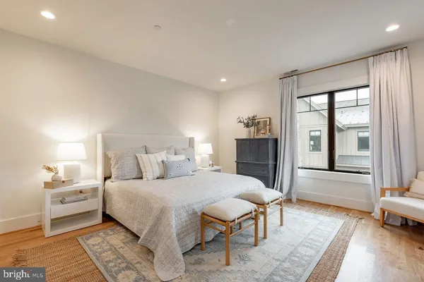 a bedroom with a large bed and a view of living room