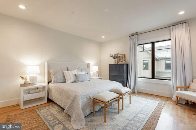 a bedroom with a large bed and a view of living room