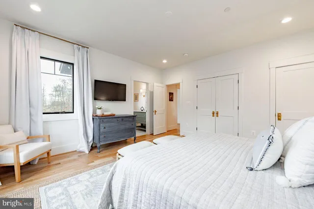 a bedroom with a bed and a flat screen tv