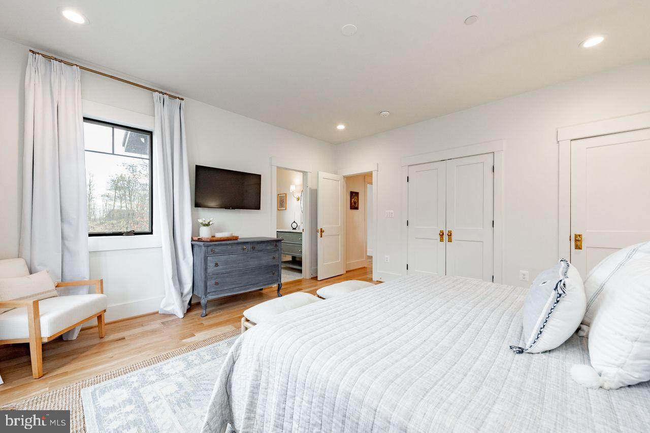 142 Ridge Run Road McHenry, MD 21541 - Photo 22 of 58 a bedroom with a bed and a flat screen tv